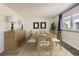 Well-lit dining room showcasing a large table with seating for eight and stylish decor at 4940 E Donald Ave # 8, Denver, CO 80222