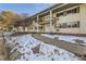 Apartment building featuring a classic facade with balconies and sidewalks dusted with snow at 4940 E Donald Ave # 8, Denver, CO 80222