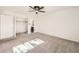 A comfortable carpeted main bedroom features a ceiling fan and walk-in closet at 4940 E Donald Ave # 8, Denver, CO 80222