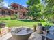Beautiful backyard features a modern fire pit, mature trees, and lush landscaping at 3135 11Th St, Boulder, CO 80304