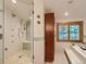 Modern bathroom featuring a glass-enclosed shower with multiple shower heads and a soaking tub at 3135 11Th St, Boulder, CO 80304