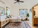 Bright bedroom with a patterned rug, ensuite bathroom, and a ceiling fan provides a comfortable retreat at 3135 11Th St, Boulder, CO 80304