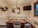 Cozy breakfast nook with cushioned seating, a pendant light, and a window with stained glass details at 3135 11Th St, Boulder, CO 80304