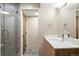 Basement bathroom with tiled shower and double vanity at 2325 S High St, Denver, CO 80210