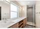 Modern bathroom with double vanity, large mirror and walk-in shower at 2325 S High St, Denver, CO 80210