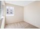Spacious bedroom with a window and neutral colored walls and carpet at 2325 S High St, Denver, CO 80210