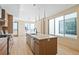 Modern kitchen features an island, stainless steel appliances, and large windows for natural light at 2325 S High St, Denver, CO 80210