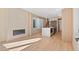Open-concept living area showcases fireplace, kitchen island, and stairs at 2325 S High St, Denver, CO 80210