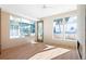 Bright living room boasts large windows, a ceiling fan, and natural light; door to outdoor area at 2325 S High St, Denver, CO 80210