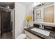 Well-lit bathroom with a sleek vanity, modern fixtures, and a glass-enclosed shower at 1050 N Corona St # 316, Denver, CO 80218