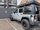 Parked jeep with a mounted camping tent on a roof rack at 1050 N Corona St # 316, Denver, CO 80218