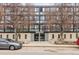 Exterior view of apartment building, showcasing its facade, address, and surrounding trees at 1050 N Corona St # 316, Denver, CO 80218