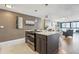 Modern kitchen with an island featuring sleek countertops and stainless steel appliances with an open view to the living room at 1050 N Corona St # 316, Denver, CO 80218