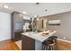 Updated kitchen island with stainless steel appliances, pendant lights, and modern finishes at 1050 N Corona St # 316, Denver, CO 80218