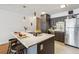 Stylish kitchen island with a sleek countertop, pendant lighting, and stainless steel appliances at 1050 N Corona St # 316, Denver, CO 80218