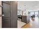 Modern kitchen with stainless steel appliances and an island with seating that opens to the living room at 1050 N Corona St # 316, Denver, CO 80218