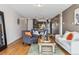 Comfortable living room with hardwood floors and neutral tones, seamlessly connecting to the modern kitchen at 1050 N Corona St # 316, Denver, CO 80218