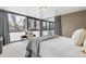 Bright bedroom with a wall of windows offering panoramic city views and neutral decor at 1050 N Corona St # 316, Denver, CO 80218