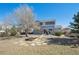 Large backyard featuring a fire pit, patio area with furniture, and a well-maintained lawn at 543 Springvale Rd, Castle Rock, CO 80104