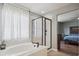 Relaxing bathroom with a soaking tub, separate shower, and natural light from the window at 543 Springvale Rd, Castle Rock, CO 80104