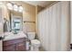 Functional bathroom with a single sink, toilet, and shower with a curtain at 543 Springvale Rd, Castle Rock, CO 80104