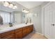 Bright bathroom featuring double sinks, white countertops, and wood cabinets at 543 Springvale Rd, Castle Rock, CO 80104