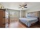 Comfortable bedroom featuring hardwood floors, ceiling fan, and a rustic-style bed and dresser at 543 Springvale Rd, Castle Rock, CO 80104