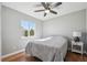 Cozy bedroom with hardwood floors, a ceiling fan, and a comfortable bed with natural light at 543 Springvale Rd, Castle Rock, CO 80104