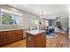 Well-lit kitchen with granite countertops open to the dining area and fireplace at 543 Springvale Rd, Castle Rock, CO 80104