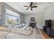 Cozy living room with stone fireplace, large window, and comfortable seating at 543 Springvale Rd, Castle Rock, CO 80104