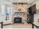 Stone fireplace with a black metal screen at 2630 S Xanadu Way # C, Aurora, CO 80014