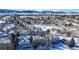 Aerial view of a snow-covered neighborhood with mountain backdrop at 6990 Orchard Ct, Arvada, CO 80007