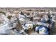 Aerial view of a residential neighborhood with houses covered in snow at 6990 Orchard Ct, Arvada, CO 80007