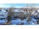 Spacious backyard with a deck, partially covered in snow, and mountain views at 6990 Orchard Ct, Arvada, CO 80007