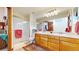 Bathroom with double sinks, a shower, and a large mirror at 6990 Orchard Ct, Arvada, CO 80007