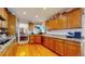 Kitchen with wood cabinets, granite countertops, and stainless steel appliances at 6990 Orchard Ct, Arvada, CO 80007