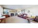 Living room with fireplace, leather couch, and hardwood floors at 6990 Orchard Ct, Arvada, CO 80007