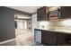 Stylish basement bar with custom shelving, tiled backsplash, and beverage refrigerator at 12606 S Sopris Creek Dr, Parker, CO 80134