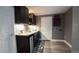 Basement bar area with dark cabinets, granite countertop, and mini fridge at 12606 S Sopris Creek Dr, Parker, CO 80134