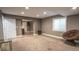 Finished basement features neutral carpet, a small window, and an adjacent room with a bar area at 12606 S Sopris Creek Dr, Parker, CO 80134