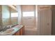 Bright bathroom featuring double sinks, a bathtub, and a clean, neutral color scheme at 12606 S Sopris Creek Dr, Parker, CO 80134