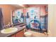 Bright bathroom with a playful shark-themed shower curtain at 12606 S Sopris Creek Dr, Parker, CO 80134