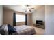 Comfortable bedroom with carpeted floors, a ceiling fan, and a large window with curtains at 12606 S Sopris Creek Dr, Parker, CO 80134