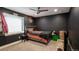 Bedroom with a dark accent wall, plush carpeting, and ample natural light at 12606 S Sopris Creek Dr, Parker, CO 80134