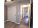 Bedroom with wood floors, closet with sliding doors, and view into another room at 12606 S Sopris Creek Dr, Parker, CO 80134
