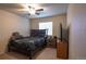 Cozy bedroom with a ceiling fan, carpeted floors, and a large window for natural light at 12606 S Sopris Creek Dr, Parker, CO 80134