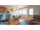 Cozy dining area with hardwood floors, a round table, and a large bay window at 12606 S Sopris Creek Dr, Parker, CO 80134