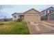 Charming single-Gathering home featuring a well-maintained lawn and attached two-car garage on a sunny day at 12606 S Sopris Creek Dr, Parker, CO 80134
