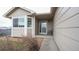 Inviting front entrance with sidelight window and an attractive well-maintained yard at 12606 S Sopris Creek Dr, Parker, CO 80134