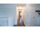 Hallway with hardwood floors leading to other rooms, offering a sense of flow and connectivity at 12606 S Sopris Creek Dr, Parker, CO 80134